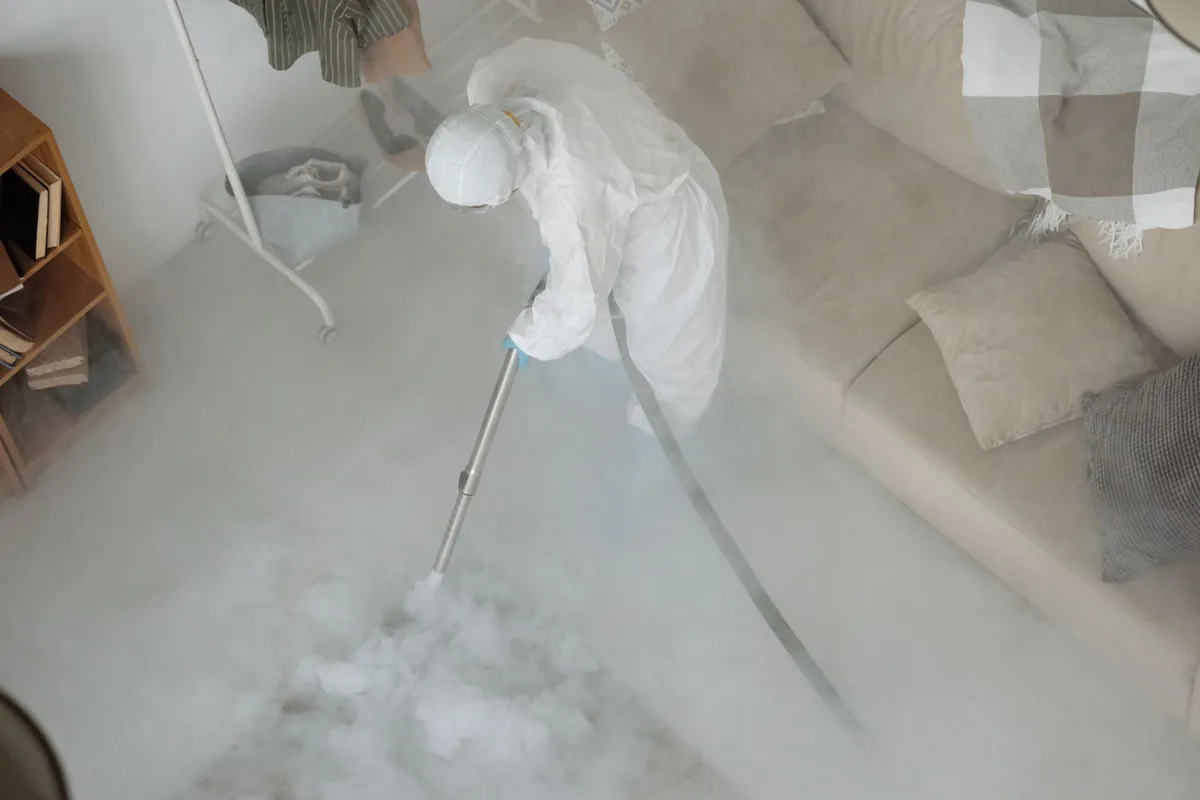 Biohazard cleanup technician in protective equipment, Highland, NY